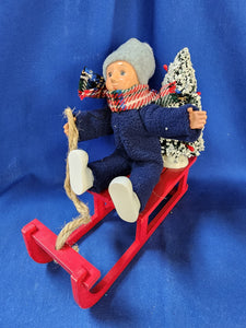 Byer's Choice Carolers "Toddler on Sled (2024)"